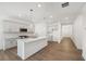 Bright kitchen features an island, stainless steel appliances, gray cabinets, and wood-look floors at 7268 Eton Ln, Locust Grove, GA 30248