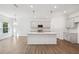Bright kitchen featuring a large island, modern lighting, and stainless steel appliances at 7268 Eton Ln, Locust Grove, GA 30248