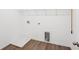 Modern laundry room with sleek flooring, washer hook-ups, dryer hook-ups, and built-in shelving at 7268 Eton Ln, Locust Grove, GA 30248