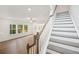Living room and staircase with gray wood floors and lots of windows at 7268 Eton Ln, Locust Grove, GA 30248