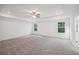 Large main bedroom with tray ceilings, recessed lights, and windows at 7268 Eton Ln, Locust Grove, GA 30248