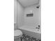 Updated bathroom with subway tile, new bathtub, and stylish flooring at 9404 Cypress Ln, Jonesboro, GA 30238