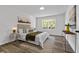 Spacious bedroom with a plush bed, large window, and stylish decor at 9404 Cypress Ln, Jonesboro, GA 30238