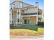 Two-story townhome with green doors and landscaping at 9404 Cypress Ln, Jonesboro, GA 30238