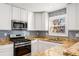 Modern kitchen with granite countertops and stainless steel appliances at 1042 Saint Charles Ne Ave # 1042-7, Atlanta, GA 30306