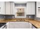 Updated kitchen with granite countertops and blue mosaic backsplash at 1042 Saint Charles Ne Ave # 1042-7, Atlanta, GA 30306