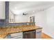 Granite countertop kitchen with breakfast bar and modern appliances at 1042 Saint Charles Ne Ave # 1042-7, Atlanta, GA 30306
