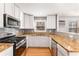 Well-equipped kitchen featuring granite countertops and white cabinets at 1042 Saint Charles Ne Ave # 1042-7, Atlanta, GA 30306