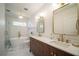 Elegant bathroom with double vanity, soaking tub, and marble tile at 1748 Terry Mill Se Rd, Atlanta, GA 30316