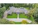 Aerial view showcases a luxury home with beautiful landscaping and a backyard pool at 3612 Castlegate Nw Dr, Atlanta, GA 30327