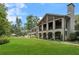 Expansive backyard featuring a well-maintained lawn, beautiful landscaping, and a view of the home's architecture at 3612 Castlegate Nw Dr, Atlanta, GA 30327
