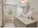 Bright bathroom features a large vanity, decorative mirror, and neutral color palette at 3612 Castlegate Nw Dr, Atlanta, GA 30327