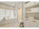Elegant bathroom showcasing a soaking tub beneath a window, with a walk-in shower, and built-in storage at 3612 Castlegate Nw Dr, Atlanta, GA 30327