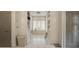 Bright and spacious bathroom features built-in shelving, marble floors, and a soaking tub beneath a window at 3612 Castlegate Nw Dr, Atlanta, GA 30327