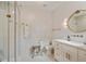 Elegant bathroom features a glass-enclosed shower, stylish vanity, and decorative gold mirror and fixtures at 3612 Castlegate Nw Dr, Atlanta, GA 30327
