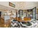 Open-concept design with a dining area adjacent to a white kitchen, featuring hardwood floors and stylish decor at 3612 Castlegate Nw Dr, Atlanta, GA 30327