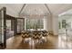 Bright dining room featuring hardwood floors, large windows, and a modern chandelier, perfect for entertaining guests at 3612 Castlegate Nw Dr, Atlanta, GA 30327