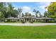 Beautiful home with a manicured lawn, elegant entrance, and a long driveway, surrounded by lush greenery at 3612 Castlegate Nw Dr, Atlanta, GA 30327