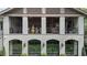 Close-up view of the home's exterior, highlighting architectural details, arched windows, and a glimpse of the screened porch at 3612 Castlegate Nw Dr, Atlanta, GA 30327