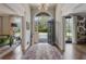 Elegant foyer featuring hardwood floors, a chandelier, and an arched entryway leading to a lush garden view at 3612 Castlegate Nw Dr, Atlanta, GA 30327