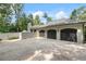 Spacious three-car garage with ample parking space, surrounded by trees, and part of the beautiful home at 3612 Castlegate Nw Dr, Atlanta, GA 30327