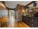 Hallway featuring designer wallpaper, wet bar with a mirrored backsplash, and seamless flow into other living spaces at 3612 Castlegate Nw Dr, Atlanta, GA 30327