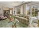 Cozy living room showing hardwood floors, fireplace, and large windows, seamlessly connecting to the dining area at 3612 Castlegate Nw Dr, Atlanta, GA 30327