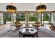 Living room features stylish chairs, elegant lighting, and large doors, creating a luxurious and inviting atmosphere at 3612 Castlegate Nw Dr, Atlanta, GA 30327