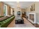 Elegant living room features a tufted green sofa, fireplace, and stylish decor at 3612 Castlegate Nw Dr, Atlanta, GA 30327