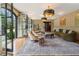 Spacious living room with a curved sofa, elegant lighting, and large doors, creating an elegant and inviting space at 3612 Castlegate Nw Dr, Atlanta, GA 30327
