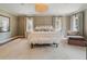 Serene bedroom with large windows, neutral tones, and plush furnishings, offering a tranquil retreat at 3612 Castlegate Nw Dr, Atlanta, GA 30327