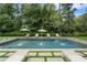 Backyard pool with lounge chairs and well manicured greenery at 3612 Castlegate Nw Dr, Atlanta, GA 30327