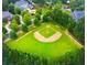 Aerial view of neighborhood baseball field surrounded by lush green trees and houses at 4927 Slaton Drive, Acworth, GA 30101