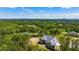 An aerial view of an expansive home with lush landscaping and a serene, wooded backdrop at 4927 Slaton Drive, Acworth, GA 30101