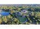 Aerial view of a large estate featuring a grand house, golf course, lake, and wooded surroundings at 4927 Slaton Drive, Acworth, GA 30101
