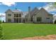 Beautiful backyard featuring a large lawn and the home's brick exterior at 4927 Slaton Drive, Acworth, GA 30101