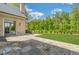 Backyard featuring a stone patio, an outdoor kitchen, and a manicured lawn at 4927 Slaton Drive, Acworth, GA 30101