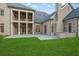 Enjoy outdoor living on the stone patio in a grassy backyard with view of the two story porch at 4927 Slaton Drive, Acworth, GA 30101