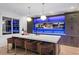 Island wet bar with barstool seating, set against a wall of large screen TVs at 4927 Slaton Drive, Acworth, GA 30101