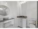 Bright bathroom featuring a vanity area and round mirror, complemented by modern fixtures and sleek finishes at 4927 Slaton Drive, Acworth, GA 30101