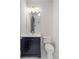 Elegant half-bath features a navy blue vanity, marble countertop, and modern fixtures at 4927 Slaton Drive, Acworth, GA 30101