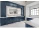 Spacious bathroom features custom blue cabinets, marble countertops, and a large, backlit mirror at 4927 Slaton Drive, Acworth, GA 30101