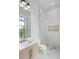 Modern bathroom features a stylish vanity, sleek fixtures, and a glass-enclosed shower with decorative tile accent at 4927 Slaton Drive, Acworth, GA 30101