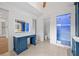 A bathroom with custom blue cabinets, marble countertops, a vanity mirror, and a glass shower enclosure at 4927 Slaton Drive, Acworth, GA 30101