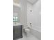 Elegant bathroom features a combination tub and shower and a vanity sink with storage at 4927 Slaton Drive, Acworth, GA 30101