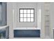 A modern blue bathtub with a marble surround sits beneath a large window offering natural light and views at 4927 Slaton Drive, Acworth, GA 30101