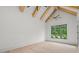 Bright bedroom featuring vaulted ceilings with wood beams and a private exterior door at 4927 Slaton Drive, Acworth, GA 30101