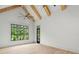 Bright bedroom featuring vaulted ceilings with wood beams and a private exterior door at 4927 Slaton Drive, Acworth, GA 30101