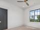 Spacious bedroom features a ceiling fan, plush carpet, and a scenic outdoor view at 4927 Slaton Drive, Acworth, GA 30101