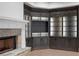 Corner built-in unit with fireplace showcases custom cabinetry, shelving, and accent lighting at 4927 Slaton Drive, Acworth, GA 30101